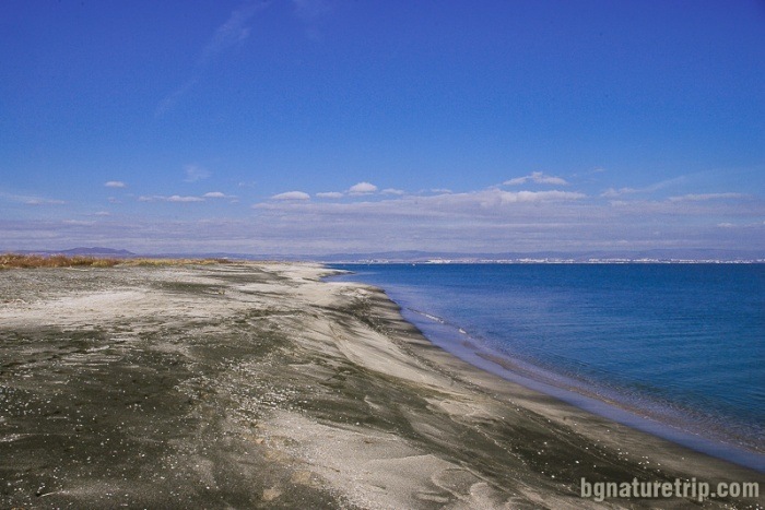 A long strip of black sand between Pomorie Lake and Black Sea