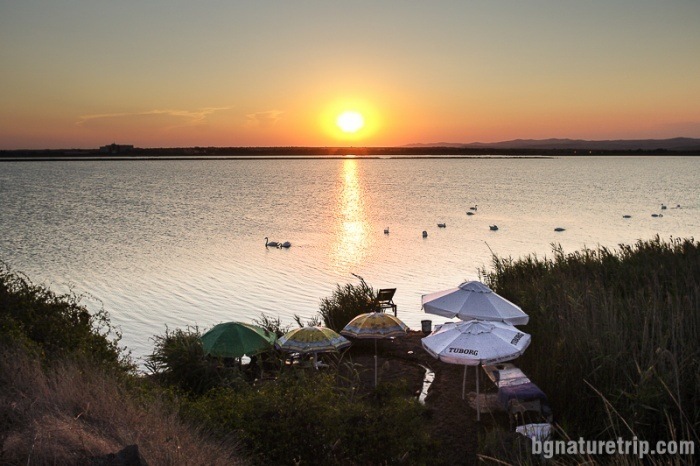 Sunset over Pomorie Lake. To the left, it is seen the building of the winery "Black Sea Gold." 
